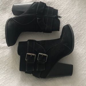 Black heeled bootie with silver buckles